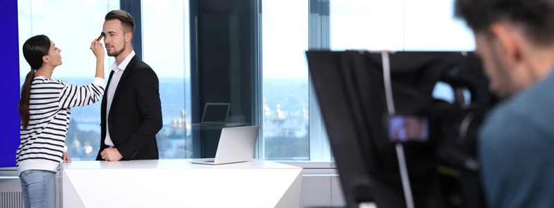 Camera operator filming a corporate video interviewee in a Melbourne office